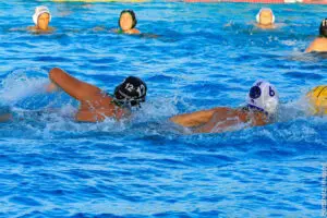 Two water polo players in action during a game.