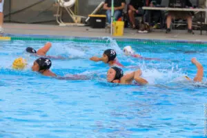 Players fiercely competing in a water polo match.
