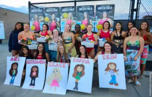 Group photo of women holding personalized cartoon posters at a fun event.