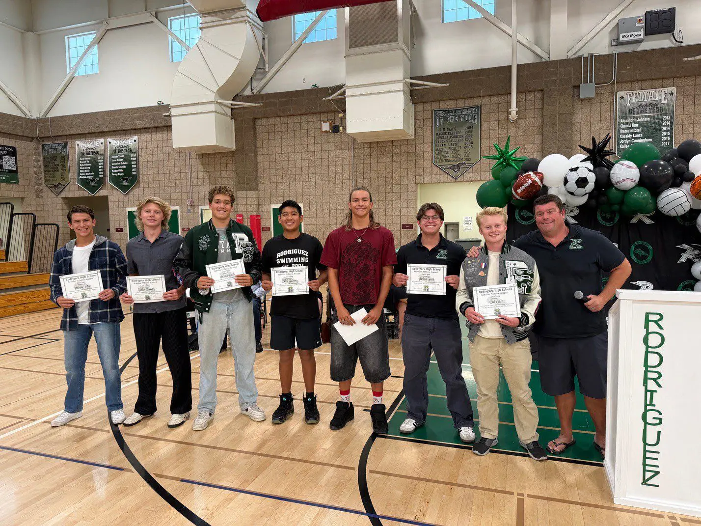 High school students receiving awards in gym