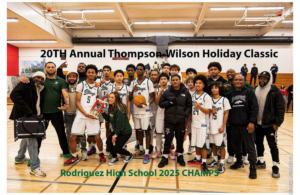 High school basketball team posing with championship banner and trophy.