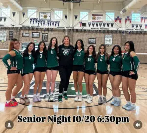 Girls' volleyball team posing on Senior Night in their uniforms.