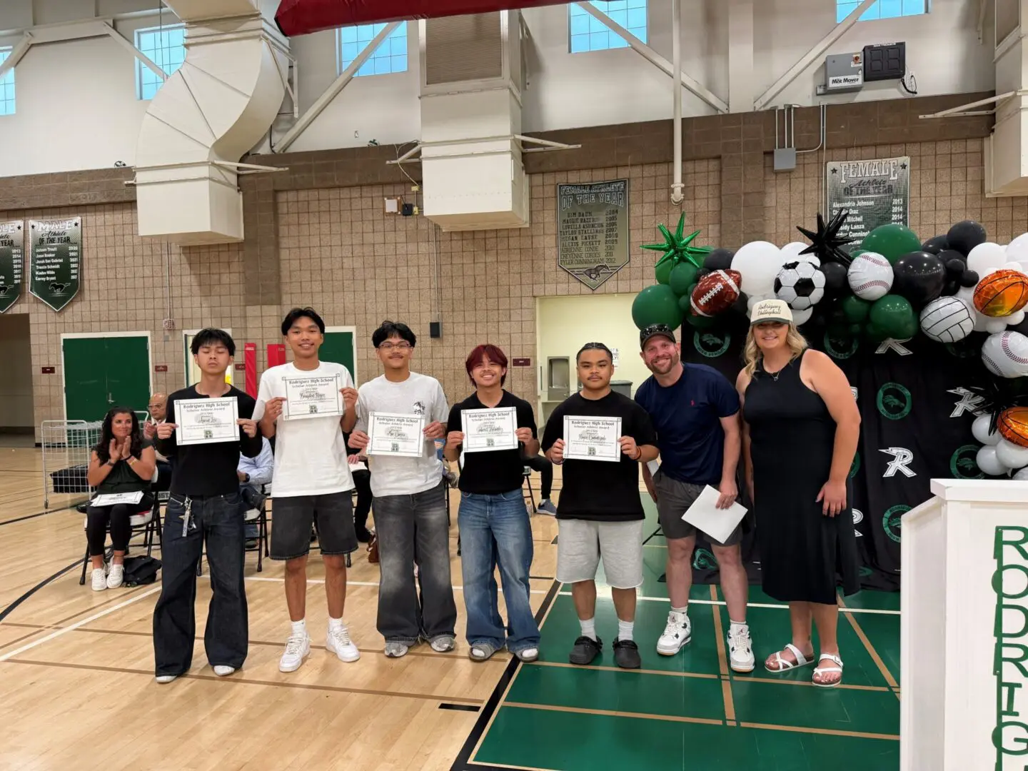 Students proudly displaying their certificates