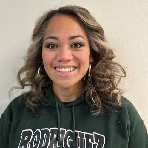 Woman in green hoodie smiling